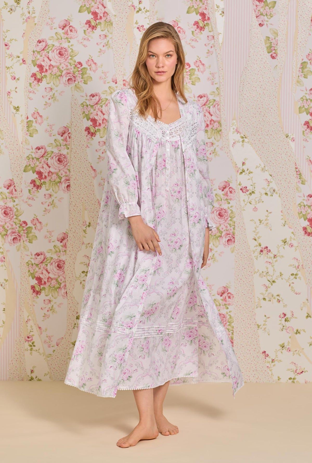 A lady wearing pink long sleeve button front cotton robe with victorian roses print.