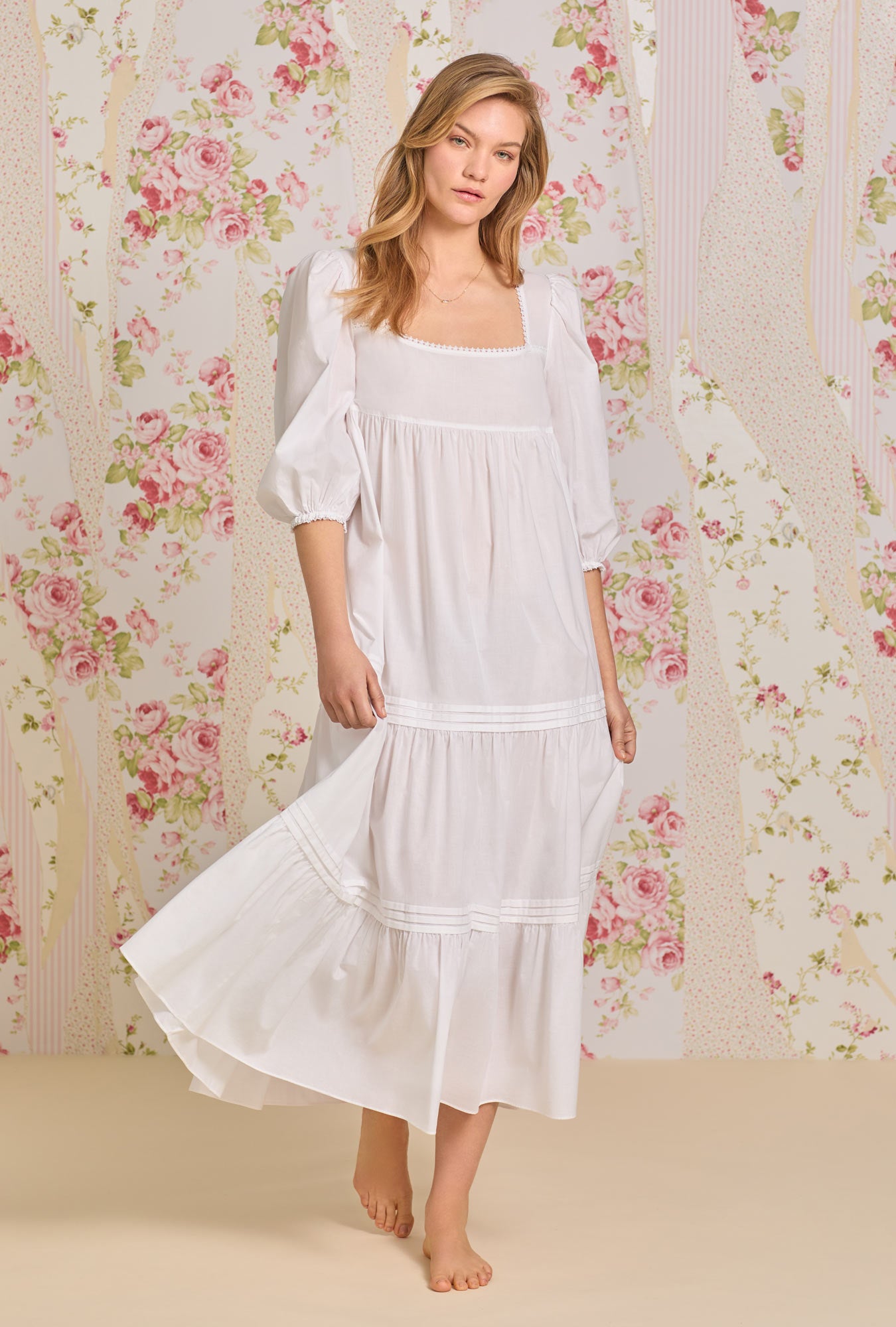 A lady wearing white 3/4 sleeve nightgown