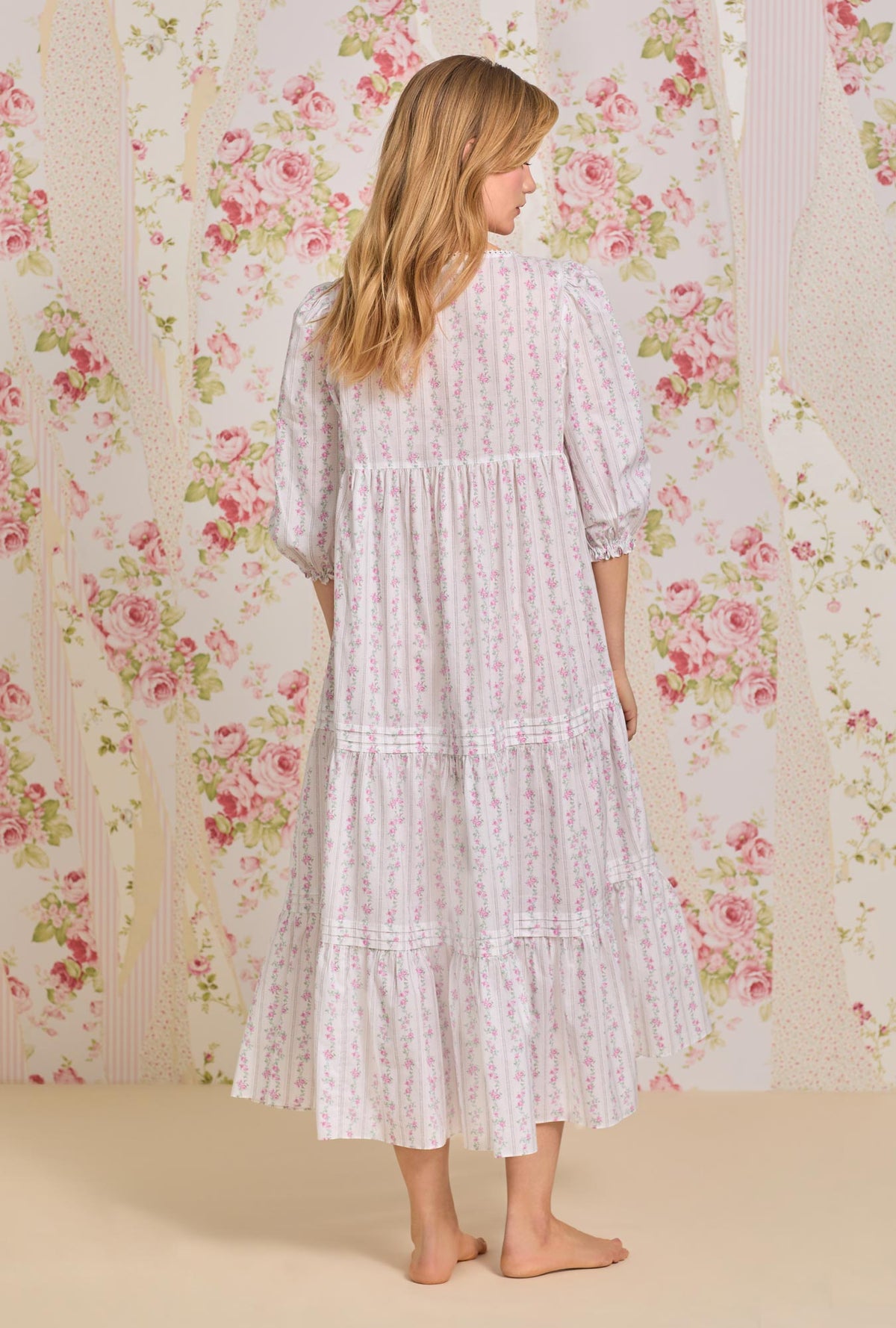 A lady wearing quarter sleeve nightdress with vintage floral stripe print.