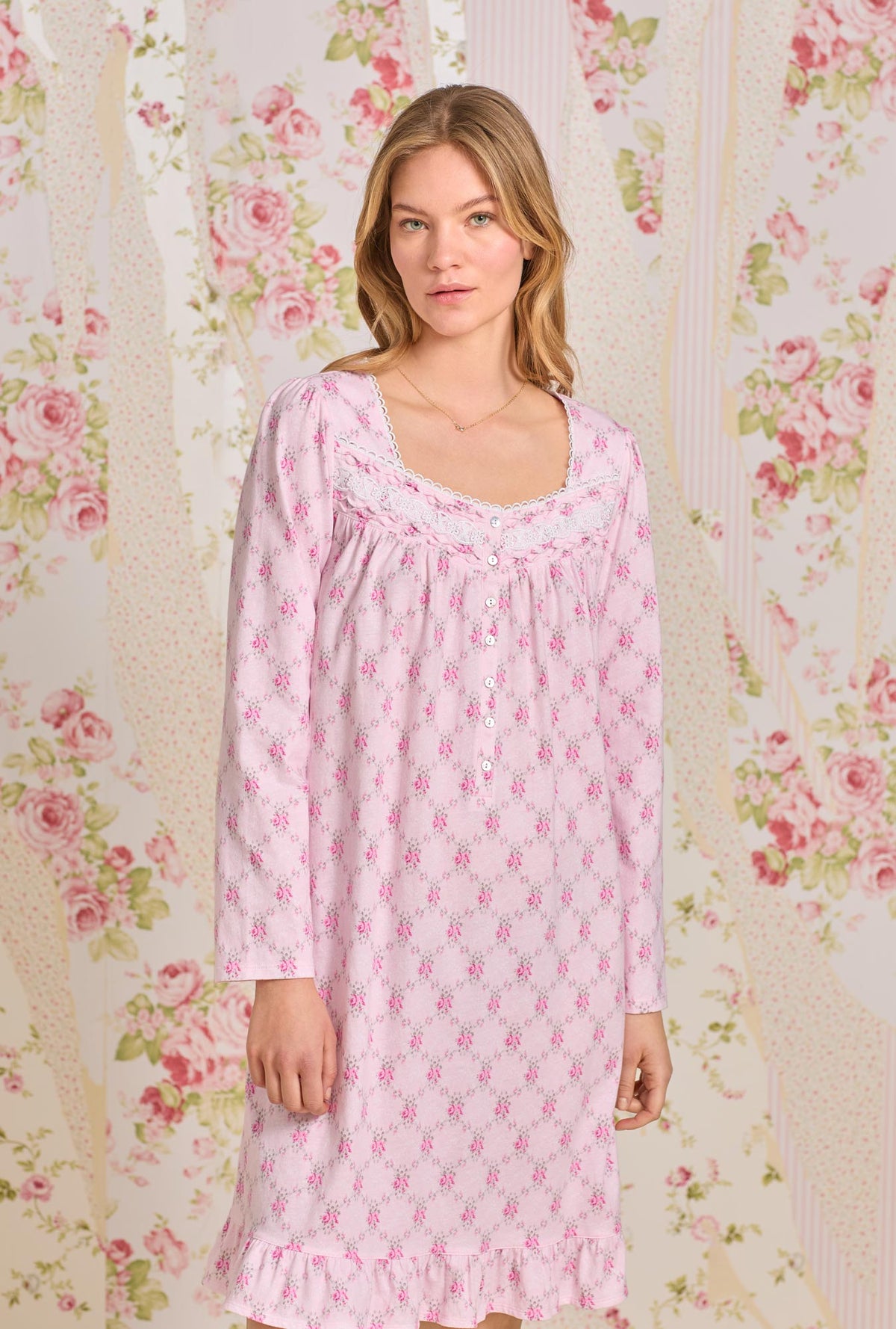 A lady wearing pink long sleeve short cotton knit nightgown with trellis rose print.