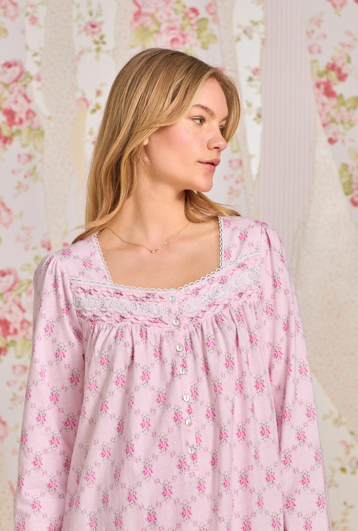 A lady wearing pink long sleeve short cotton knit nightgown with trellis rose print.