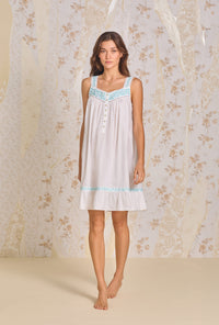 A lady wearing Iconic White Aqua Embroidery Cotton Lawn Chemise