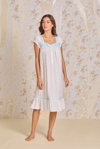 A lady wearing Iconic White Aqua Embroidery Cotton Lawn Waltz Nightgown