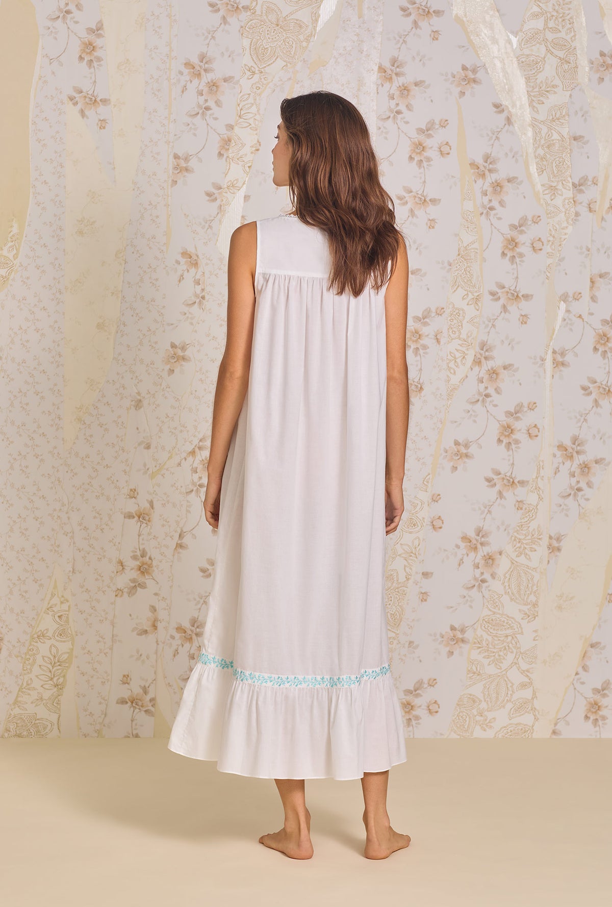 A lady wearing Iconic White Aqua Embroidery &quot;Eileen&quot; Cotton Lawn Nightgown