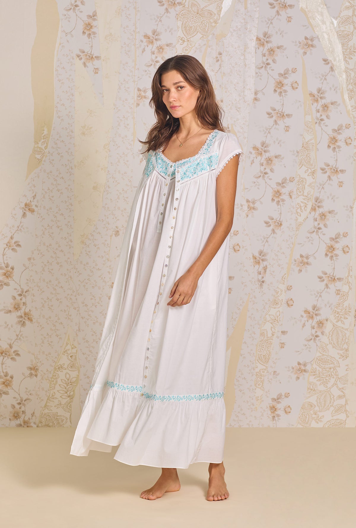 A lady wearing Iconic White Aqua Embroidery Cotton Lawn Button Front Robe