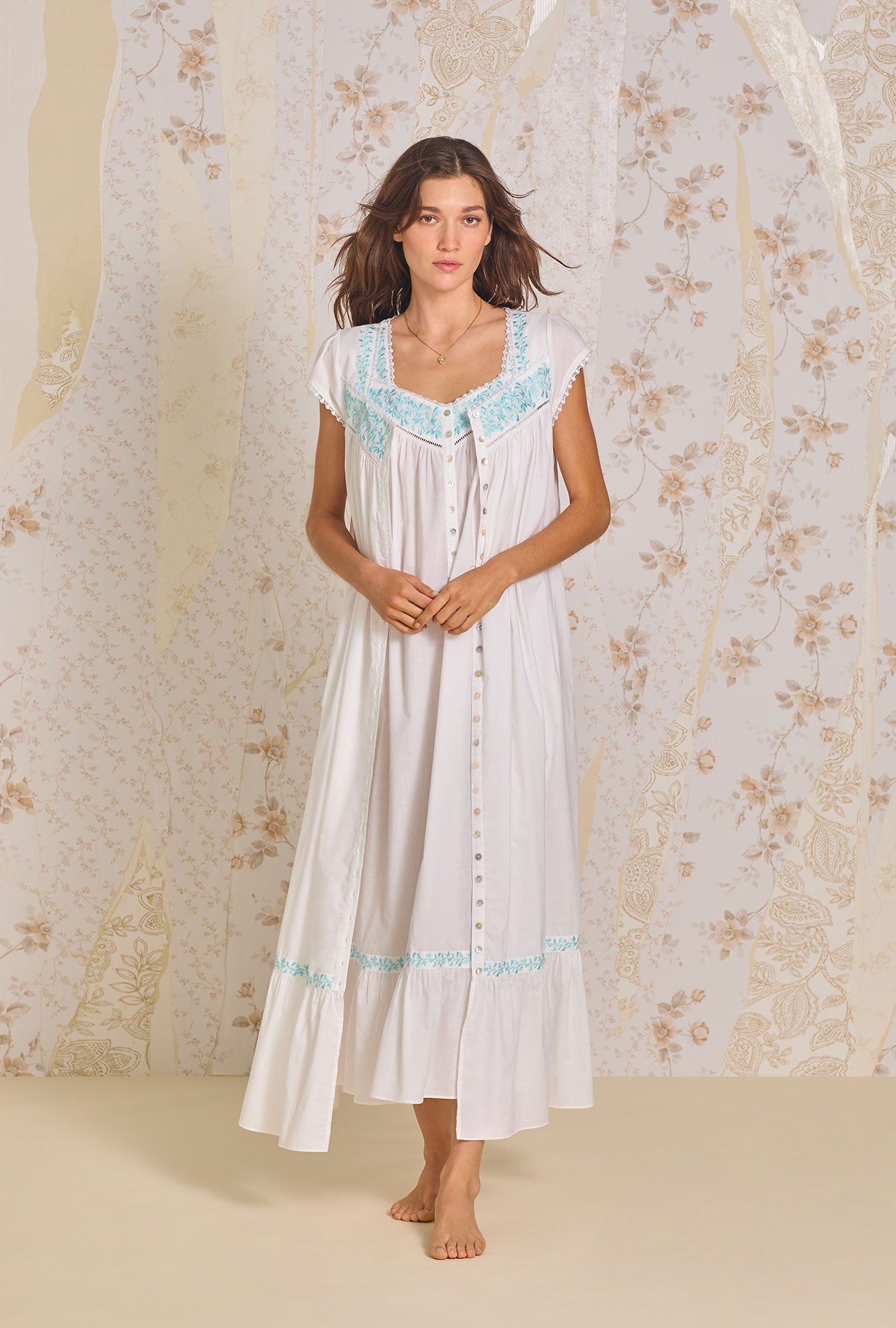 A lady wearing Iconic White Aqua Embroidery Cotton Lawn Button Front Robe