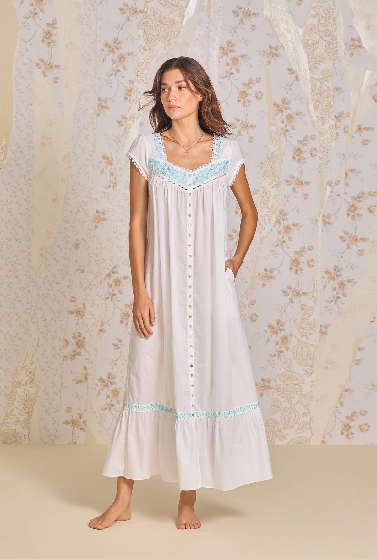 A lady wearing Iconic White Aqua Embroidery Cotton Lawn Button Front Robe