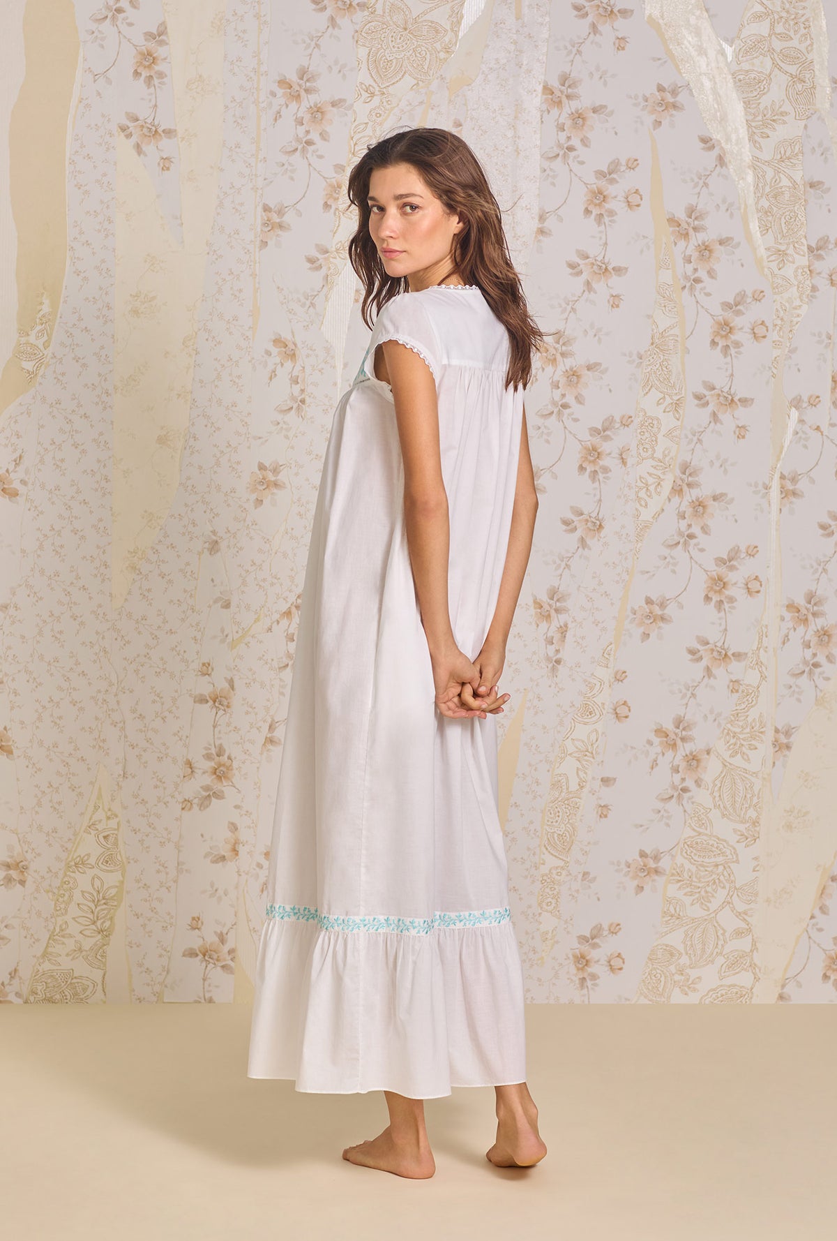 A lady wearing Iconic White Aqua Embroidery Cotton Lawn Button Front Robe